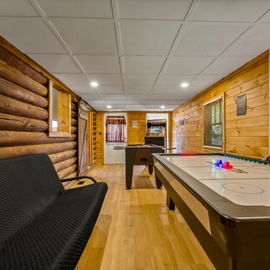 Your private game room features air hockey and pool tables surrounded by warm wood paneling—perfect for friendly competition.