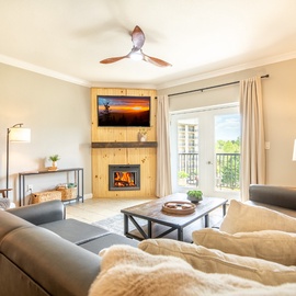 Cozy up by your crackling fireplace in this inviting living room, with plush seating and warm lighting creating the perfect retreat.