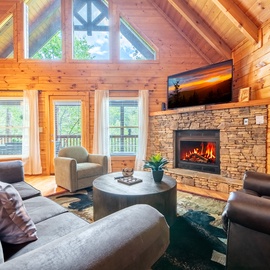 Cozy up in this warm cabin living room where crackling flames and rustic charm create your perfect mountain retreat sanctuary.