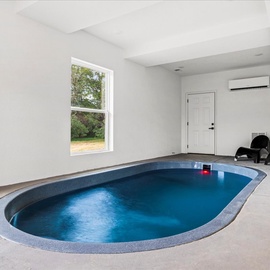 Dive into your private indoor pool oasis, complete with cozy seating and climate control for year-round relaxation.