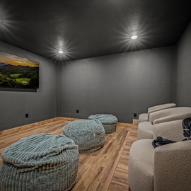 Unwind in your private theater with plush seating and cozy bean bags for the ultimate movie night experience.