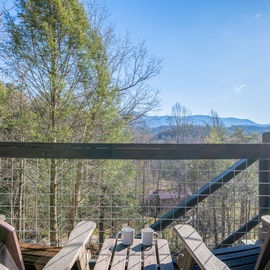Scenic mountain views frame this peaceful deck where morning coffee tastes better surrounded by rolling hills and fresh air.