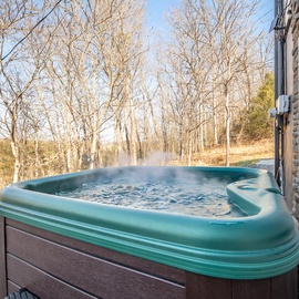 Soak your worries away in this steaming hot tub while enjoying peaceful wooded views from your private deck.