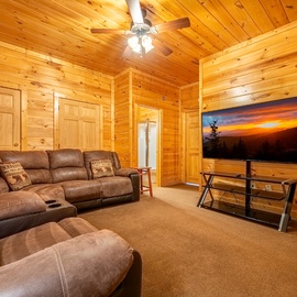 Sink into plush recliners and lose yourself in movie nights on the big screen, surrounded by warm wood walls that make every evening feel like a cozy mountain retreat.