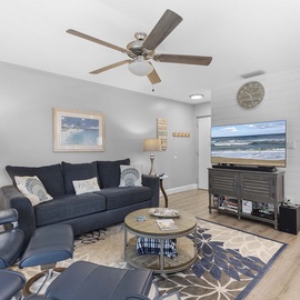 The living room has a large flat-screen TV