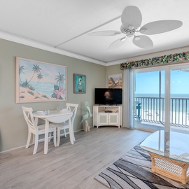 Dining area and living room with Sliders leading to Screened in Patio.