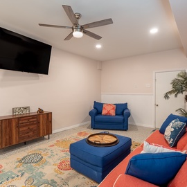 First floor Living room, with mounted tv and access to pool- ground level