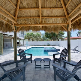 Enjoy your time under the tiki pool side.