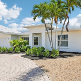 Entrance with beautiful, lush landscaping.