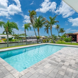 Wonderful backyard with a big pool and resting on a canal.