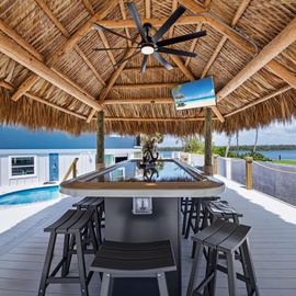 Enjoy this Tiki Bar that seats 12 with surround sound tv and light features to maximize night time fun!