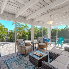 Relax in the shade in screened in patio area.