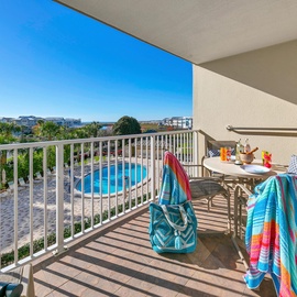Start your morning with coffee on your private balcony, overlooking the sparkling pool and vibrant resort grounds below.