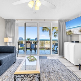 Step into your coastal retreat where the living room opens to a private balcony with stunning ocean views. Relax on plush seating as sea breezes drift through, blending comfort with beachfront beauty.