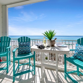 Step onto your private balcony with turquoise chairs and ocean views - your perfect spot for morning coffee or sunset cocktails.