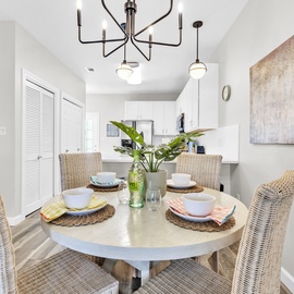 Gather around this inviting dining table where your morning coffee and evening meals become memorable moments in this bright, stylish space.