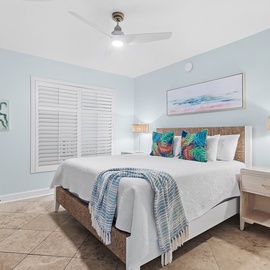 Drift off to sleep in your tranquil guest bedroom, where light coastal walls and tropical touches create your ideal sanctuary.