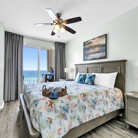 Doze off to stunning ocean views from the cozy master bedroom, where coastal-themed decor and gentle sea breezes create the perfect seaside retreat.
