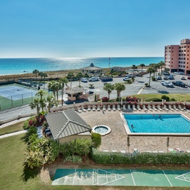Beachfront Islander Beach Resort featuring pools, tennis courts, and direct beach access with tropical landscaping and convenient parking.
