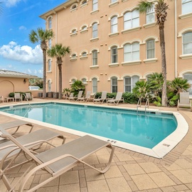 Dive into crystal-clear waters surrounded by swaying palms and comfortable loungers in your private pool oasis.