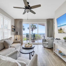 Sink into plush coastal comfort while ocean breezes flow through your bright living space, complete with calming beach artwork and balcony access.