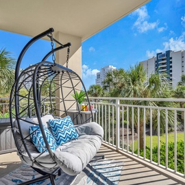 Sway gently in your private hanging chair while soaking up tropical views and warm sunshine on this peaceful balcony retreat.