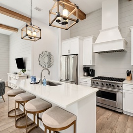 The kitchen is equipped with many appliances for various cooking needs.