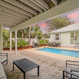Take a break from the sun with cozy, shaded seating near the pool.
