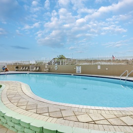 Crystal clear pool surrounded by comfortable lounge chairs where you can soak up the Florida sunshine under endless blue skies.