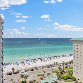 Stunning gulf view with pristine white sand beach and turquoise waters stretching to the horizon under bright blue skies.