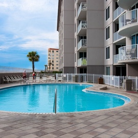 Dive into your own slice of paradise with this sparkling pool surrounded by comfortable loungers, all set against beautiful blue skies.