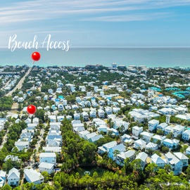 Aerial view of a charming coastal community with beach access just moments away from pristine turquoise waters.