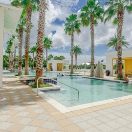 Your tropical oasis awaits with sparkling pools surrounded by swaying palms and modern poolside pavilions.