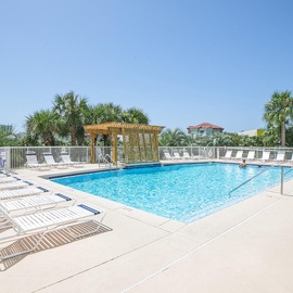 Sparkling pool deck with tropical palms and loungers awaits your perfect vacation days.