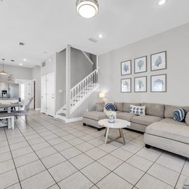 Sink into your comfortable sectional sofa in this bright, open living space where coastal touches create a relaxing retreat.