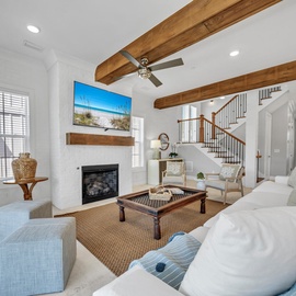 Sink into plush sofas beneath stunning exposed beams while your favorite show plays on the mounted TV above the cozy fireplace.