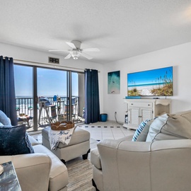 Sink into plush sofas while enjoying your Gulf view and beach-themed decor in this bright, coastal living room.
