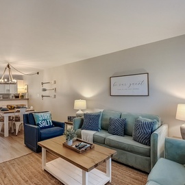 Sink into plush seating with ocean-inspired blues while your open kitchen beckons for morning coffee and evening meals.