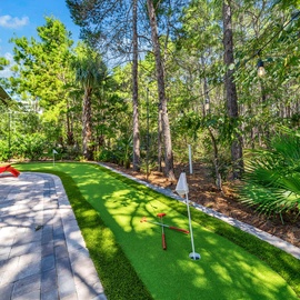 Practice your putting skills on your private mini golf course, surrounded by lush tropical landscaping and towering pines.