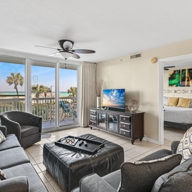 Unwind in your spacious beachfront living room with stunning beach views, comfortable seating, and a private balcony perfect for morning coffee.