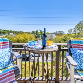 Sip your morning coffee on this charming balcony overlooking lush treetops and peaceful neighborhoods.
