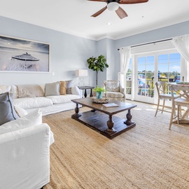 Unwind in your bright, coastal-inspired living space with plush seating and charming dining nook that opens to your private balcony.