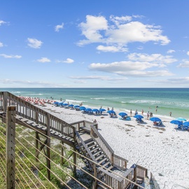 Stunning beachfront location with pristine white sand and crystal-clear waters just steps from the property.