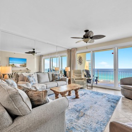 Sink into plush seating while ocean breezes flow through your spacious living room, where floor-to-ceiling windows frame endless sea views.