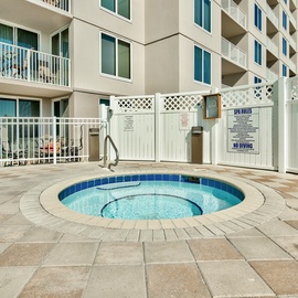 Soak your cares away in this private spa area featuring a bubbling hot tub surrounded by pristine tile decking.