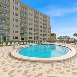 Sparkling Islander Beach Resort pool surrounded by comfortable loungers where you can soak up the sun on beautiful brick-paved deck.