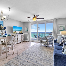 Your beachfront retreat awaits with stunning Gulf views from every window, inviting blue furnishings, and a bright dining space perfect for morning coffee.