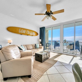 Welcome to Water's Edge 413 - Gone Coastal! Relax in your coastal living room with ocean-inspired decor and stunning views through floor-to-ceiling windows.