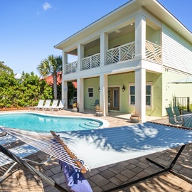 Backyard has: hammock, outdoor dining, lounge chairs and gas grill