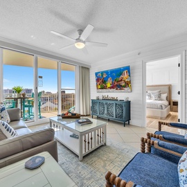 Relax in your bright living space with ocean-themed decor, comfortable seating, and stunning city views from your private balcony.